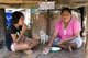 Thailand: An Urak Lawoi (Sea Gypsy) mother and daughter eat lunch, Laem Tukkae, Phuket